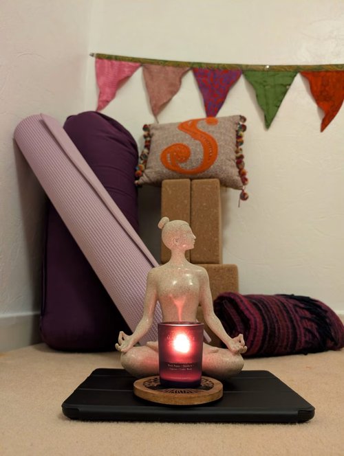The Zen Den, Stephanie's cosy home studio space in Paisley, set up with mats, blocks, and a bolster